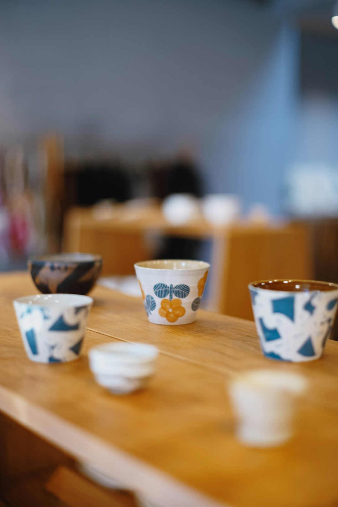 Handmade ceramic cups arranged on a wooden table