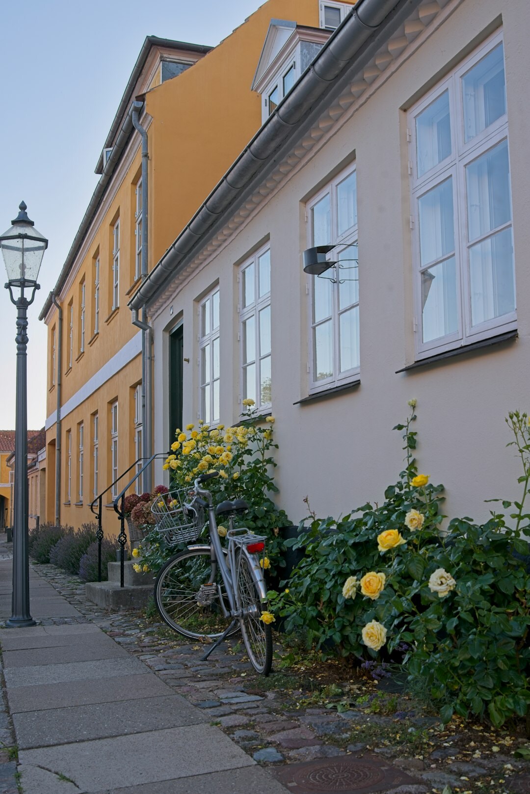 Cyclist riding through a cobblestone street in a Danish town