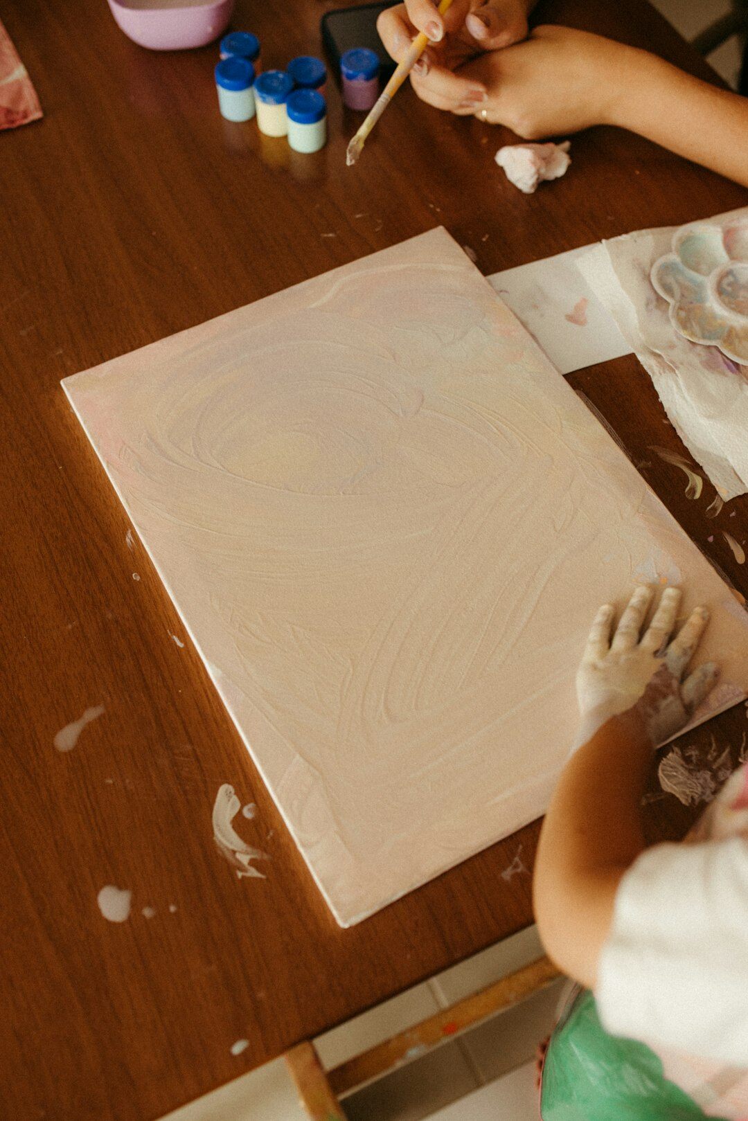 young artist with paintbrushes
